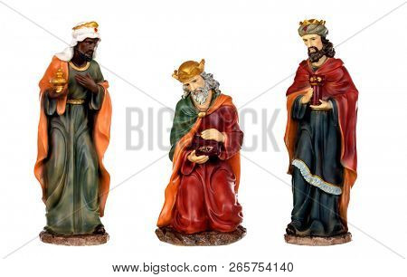 The three wise men and baby Jesus. Ceramic figures isolated on white background