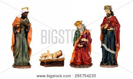 The three wise men and baby Jesus. Ceramic figures isolated on white background