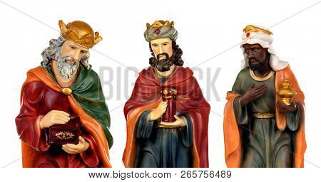 The three wise men and baby Jesus. Ceramic figures isolated on white background