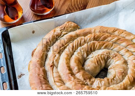 Round Borek In Tray / Greek Cheese Pie On Wooden Surface