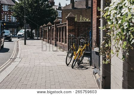 London, Uk - August 1, 2018: Yellow Ofo Bikes On A Street In London. Ofo Is A Dockless Bike-sharing 