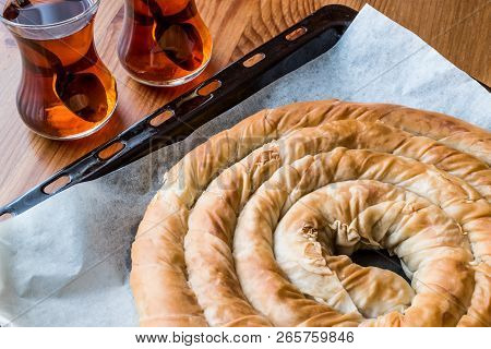 Turkish Tepsi Boregi / Round Borek In Tray With Tea.