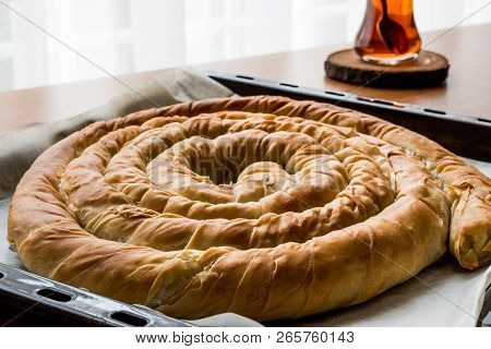 Turkish Tepsi Boregi / Round Borek In Tray With Tea.