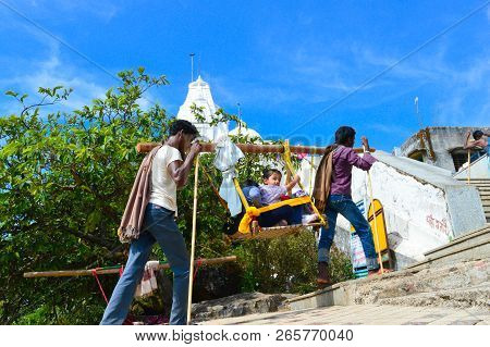 Kedarnath, Amarnath, India- October, 2017: Kashmiri Porters Carry Tourists Seated In Sedan Chair Dur