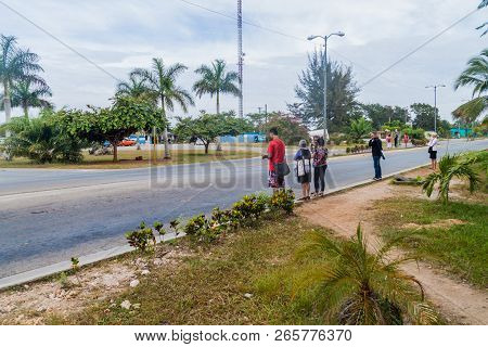 Playa Larga, Cuba - Feb 16, 2016: Hitchhikers Wait At A Roadside In Playa Larga Village, Cuba.