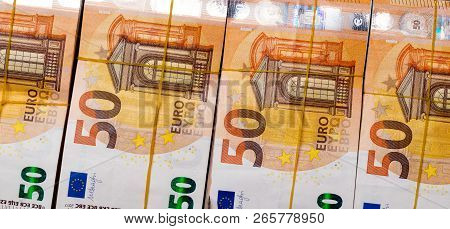 Pile Of 50 Real Euro Notes 50-euro Banknotes Under Rubber Band Isolated On Black. About 20000 Euros 