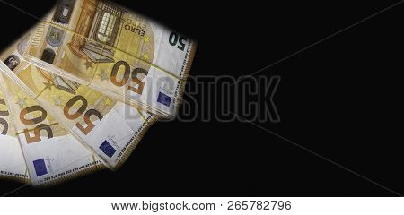 Pile Of 50 Real Euro Notes 50-euro Banknotes Under Rubber Band Isolated On Black. About 20000 Euros 