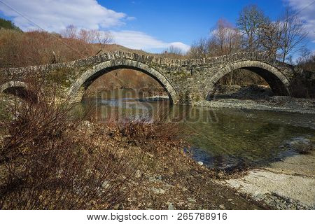 Ancient Snone Bridge Over River In Zagorohoria, Greece