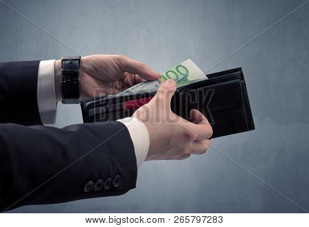 Businessman's hand in suit takes out eruo from his wallet