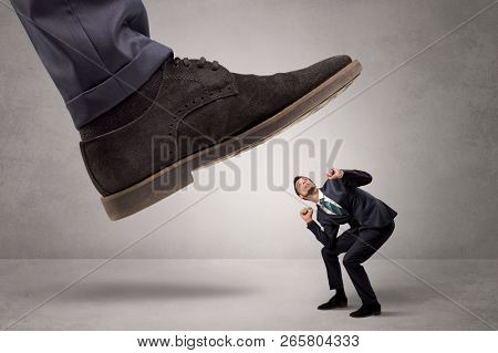 Young businessman illustrated inconsiderable by being trampled