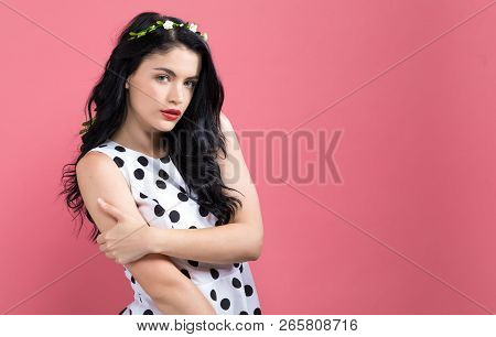 Fashionable Woman With A Garland On A Pink Background
