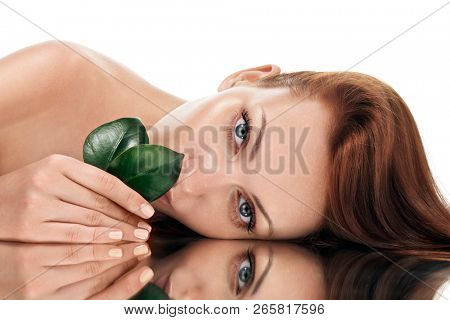 Beautiful young woman with grean leaves. Organic beauty concept.