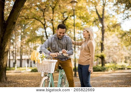 Active Senior Couple Together Enjoying Romantic Walk With Bicycle In Golden Autumn Park