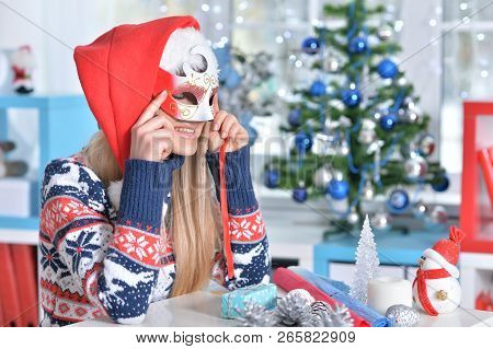 Portrait Of A Smiling Woman Preparing For Christmas