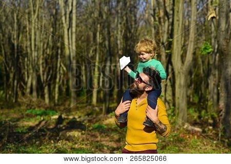Father And Son Enjoy Walking In Spring Park. Father And Child Enjoy Sunny Day Outdoor. Love Puts The