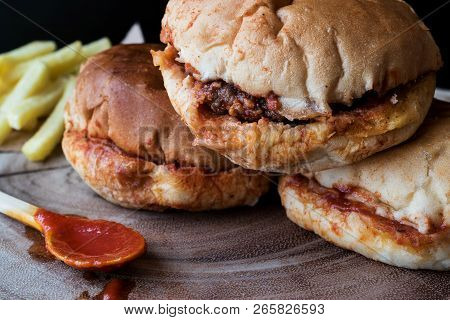 Turkish Wet Burger With Sauce And Potatoes. / Islak Hamburger On A Wooden Surface.