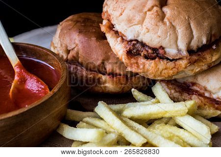 Turkish Wet Burger With Sauce And Potatoes. / Islak Hamburger On A Wooden Surface.