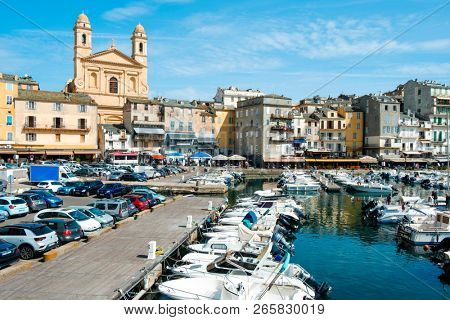 BASTIA, FRANCE - SEPTEMBER 16, 2018: A view of the Vieux Port, the Old Port of Bastia, in Corsica, France, highlighting the Saint-Jean-Baptiste Church with its characteristic twin bell towers