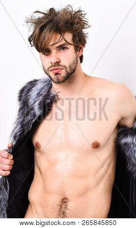 Guy Attractive Fashion Model Posing Fur Coat On Naked Body. Fashion And Pathos. Fashion Concept. Ric