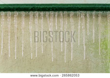 Icing Of Outdoor Steel Piping At Winter Season. Icy Icicles Gutter After Thaw.