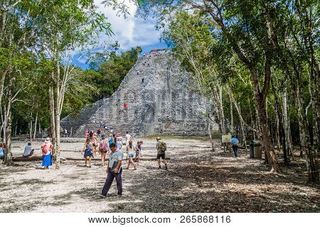 Coba, Mexico - March 1, 2016: Tourist Visit The Pyramid Nohoch Mul At The Ruins Of The Mayan City Co