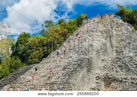 Coba, Mexico - March 1, 2016: Tourist Climb The Pyramid Nohoch Mul At The Ruins Of The Mayan City Co