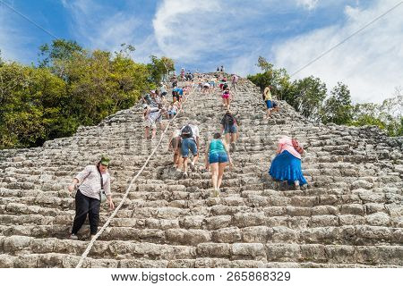 Coba, Mexico - March 1, 2016: Tourist Climb The Pyramid Nohoch Mul At The Ruins Of The Mayan City Co