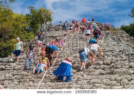 Coba, Mexico - March 1, 2016: Tourist Climb The Pyramid Nohoch Mul At The Ruins Of The Mayan City Co