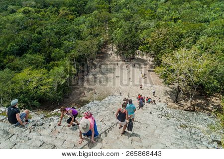 Coba, Mexico - March 1, 2016: Tourist Climb The Pyramid Nohoch Mul At The Ruins Of The Mayan City Co