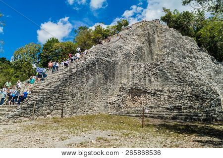 Coba, Mexico - March 1, 2016: Tourist Climb The Pyramid Nohoch Mul At The Ruins Of The Mayan City Co