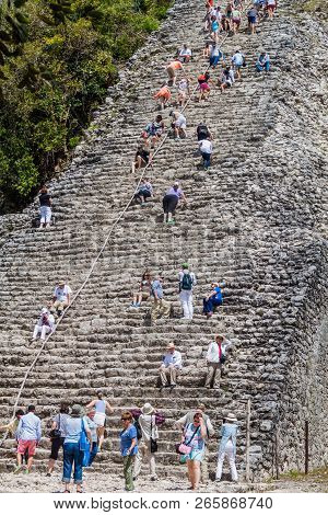 Coba, Mexico - March 1, 2016: Tourist Climb The Pyramid Nohoch Mul At The Ruins Of The Mayan City Co