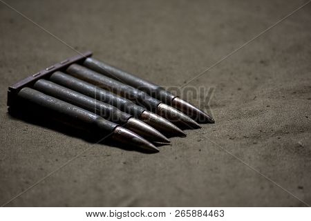Holder With Cartridges 7, 92 X 57 - Rustic Ammos And Poncho Lies On The Wooden Background