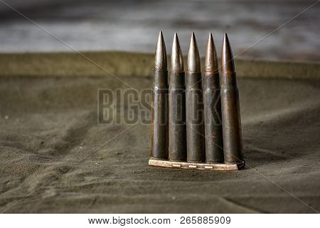 Holder With Cartridges 7, 92 X 57 - Rustic Ammos And Poncho Lies On The Wooden Background