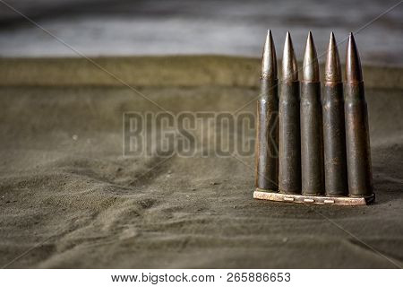 Holder With Cartridges 7, 92 X 57 - Rustic Ammos And Poncho Lies On The Wooden Background