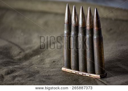 Holder With Cartridges 7, 92 X 57 - Rustic Ammos And Poncho Lies On The Wooden Background