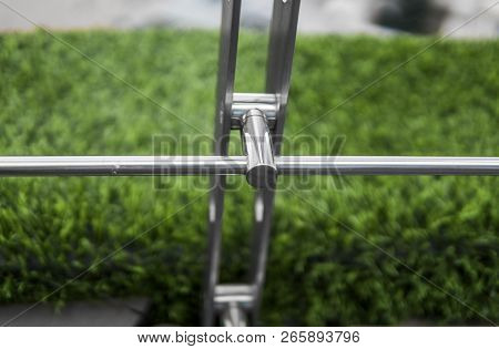 Details Of Fence Made Of Stainless Steel Profile With An Artificial Raffa On The Background.