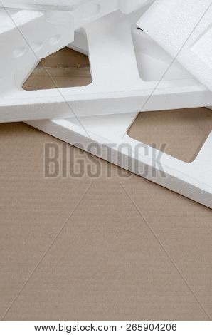 Background Image With Beige Cardboard Paper And Styrofoam Boxes Disgarded As Rubbish. The Concept Of