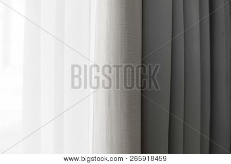 Close-up View Of Bright Curtain In Thin And Thick Vertical Folds Made Of Dense Fabric.textured Abstr