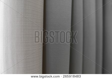 Close-up View Of Bright Curtain In Thin And Thick Vertical Folds Made Of Dense Fabric.textured Abstr