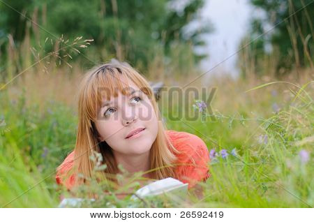 Woman reading a  book at meadow
