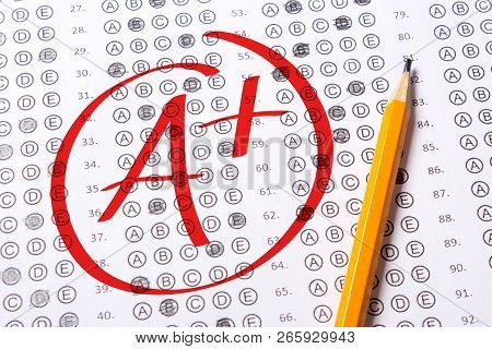 Good Grade Of A Plus Is Written With  Red Pen On The Tests.