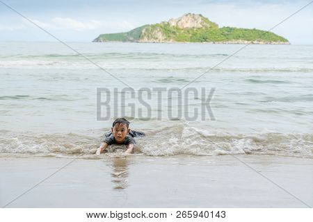 Asian Boy Enjoying In The Sea Near The Beach At Ao Manao, Prachuap Khiri Khan, Thailand In The After