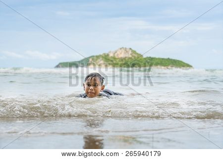 Asian Boy Enjoying In The Sea Near The Beach At Ao Manao, Prachuap Khiri Khan, Thailand In The After
