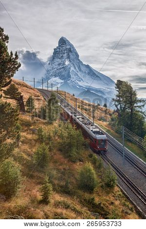Matterhorn Peak With A Train Against Sunset In Swiss Alps, Switzerland