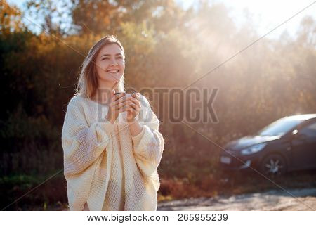 Beautiful Admiring Woman Drinking Hot Tea From Thermos Cup With Backligth Sun.