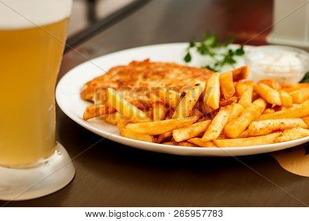Vienna Schnitzel And French Fries. Traditional Austrian Dish.