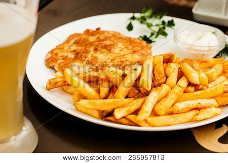 Vienna Schnitzel And French Fries. Traditional Austrian Dish.