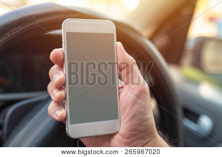 Using Smartphone In Car, Mock Up Blank Screen Of Mobile Phone Device In Hand Of Adult Caucasian Male