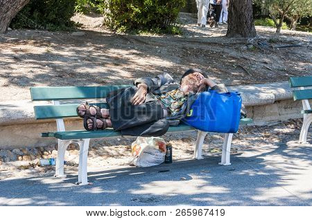 Avignon, France - July 24, 2011: Homeless Man Is Sleeping Oudoors In Old Town With Knife Under The B