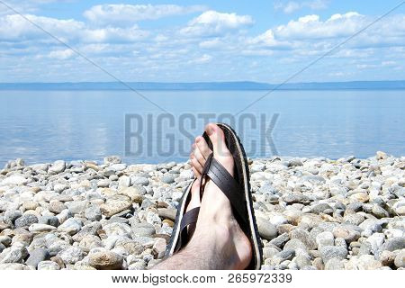 Feet In Slates On A Pebble Beach On Lake Baikal